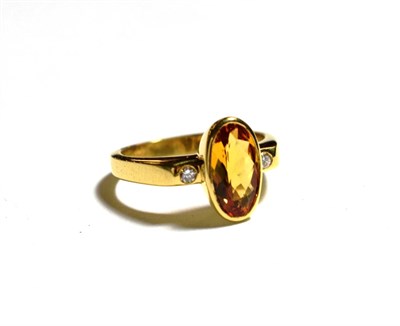 Lot 354 - An 18 carat gold citrine and diamond three stone ring, finger size M1/2