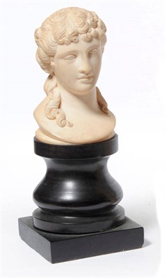 Lot 961 - A Carved Elephant Ivory Bust of a Pretty Young Woman, probably French, circa 1850, her curling hair