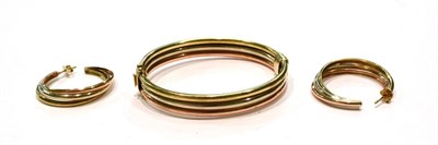 Lot 434 - A 9 carat gold tri-colour bangle; and a pair of similar earrings, unmarked