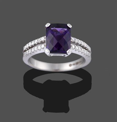 Lot 2005 - An 18 Carat White Gold Amethyst and Diamond Ring, the pineapple cut amethyst in a white four...