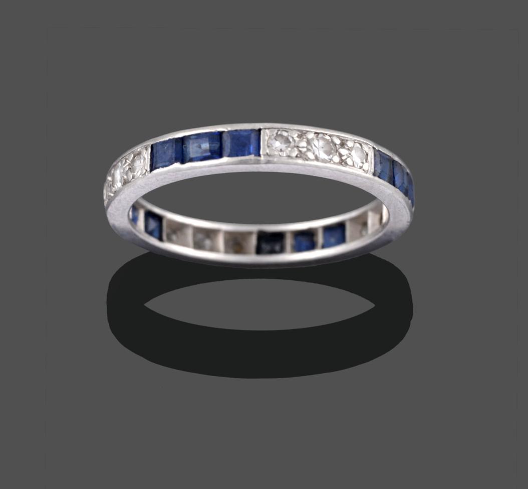 Lot 2007 - A Sapphire and Diamond Eternity Ring, trios of square step cut sapphires alternate with trios...