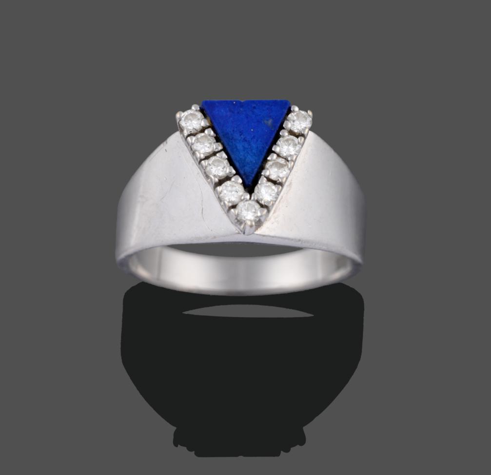 Lot 2009 - A Contemporary Lapis Lazuli and Diamond Ring, a triangular panel of lapis lazuli with round...