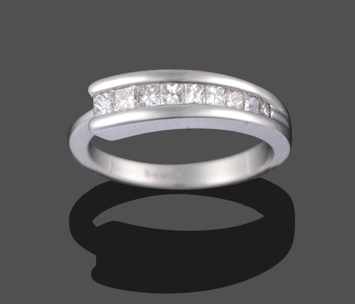 Lot 2011 - A Contemporary 18 Carat White Gold Diamond Half Hoop Ring, nine graduated princess cut diamonds...