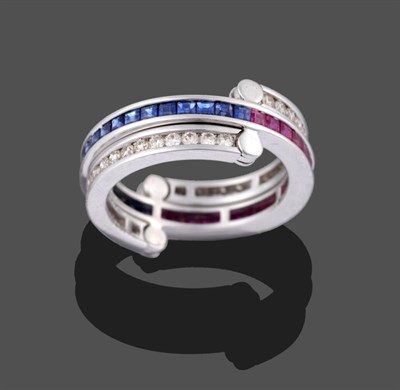 Lot 2012 - A Ruby, Sapphire and Diamond Eternity 'Flip' Ring, the main band channel set in white with step cut