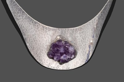 Lot 2014 - A White Metal Amethyst Torque Collar, a planished white metal collar with a cluster of raised rough