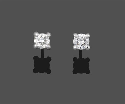 Lot 2016 - A Pair of 18 Carat White Gold Diamond Solitaire Earrings, the round brilliant cut diamonds in...