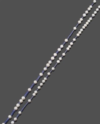 Lot 2019 - A Tanzanite and Cultured Pearl Necklace, smooth tanzanite beads spaced by cultured pearls,...