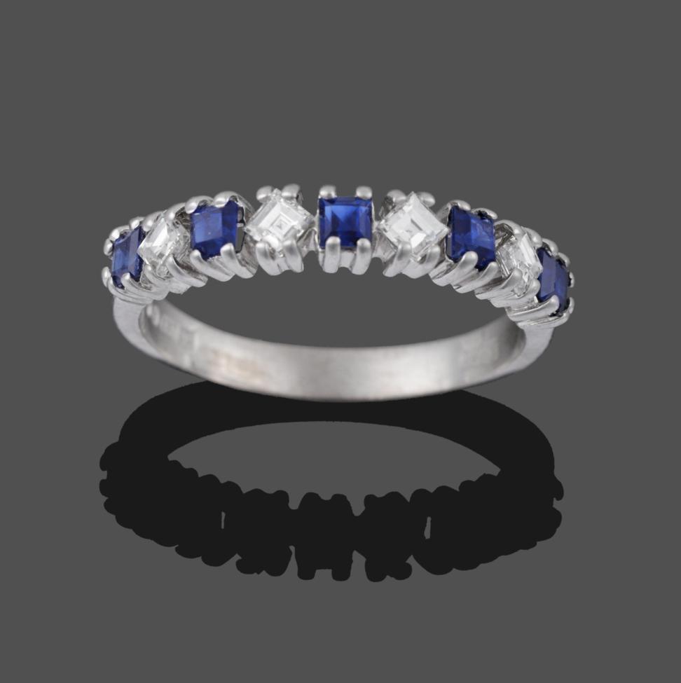 Lot 2027 - An 18 Carat White Gold Sapphire and Diamond Half Hoop Ring, square step cut sapphires alternate...