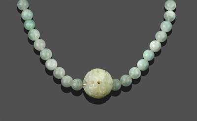 Lot 2030 - A Jade Necklace, sixty-six spherical jade beads with a larger ornately carved jade bead hung...