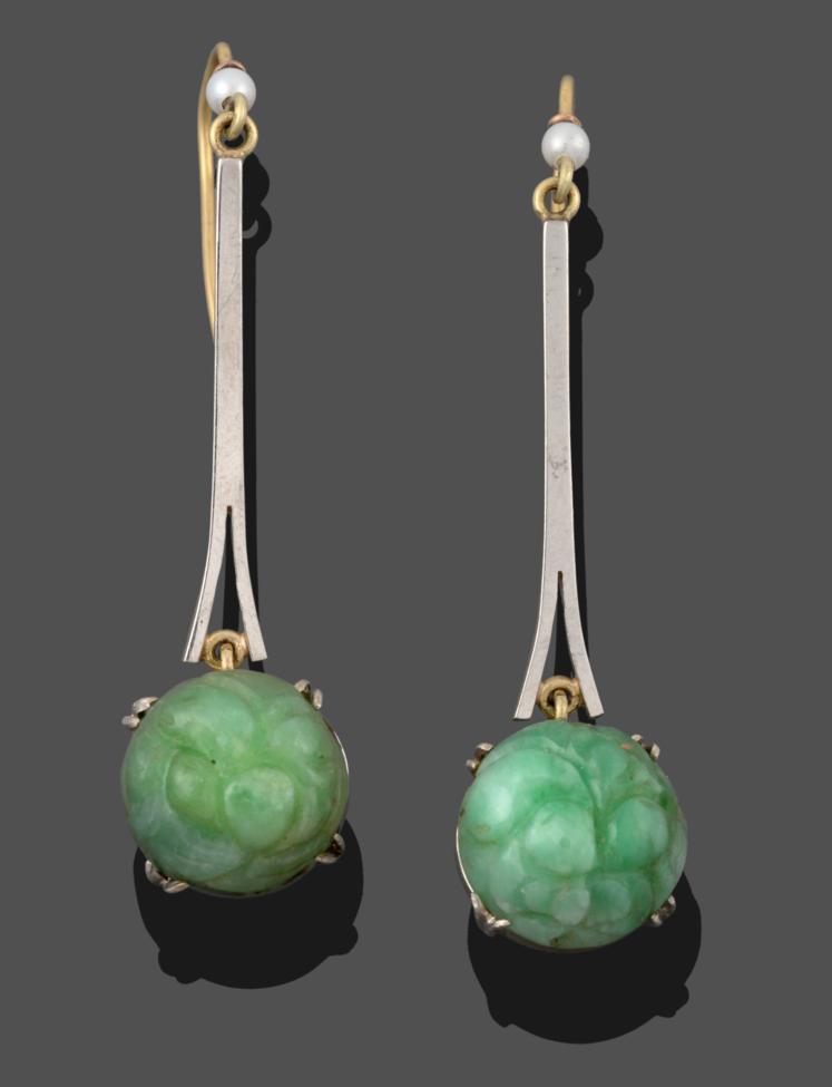 Lot 2031 - A Pair of Jade and Cultured Pearl Drop Earrings, an ornately carved jade cabochon in a white...