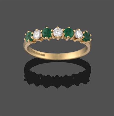 Lot 2033 - An 18 Carat Gold Emerald and Diamond Seven Stone Ring, three round brilliant cut diamonds alternate