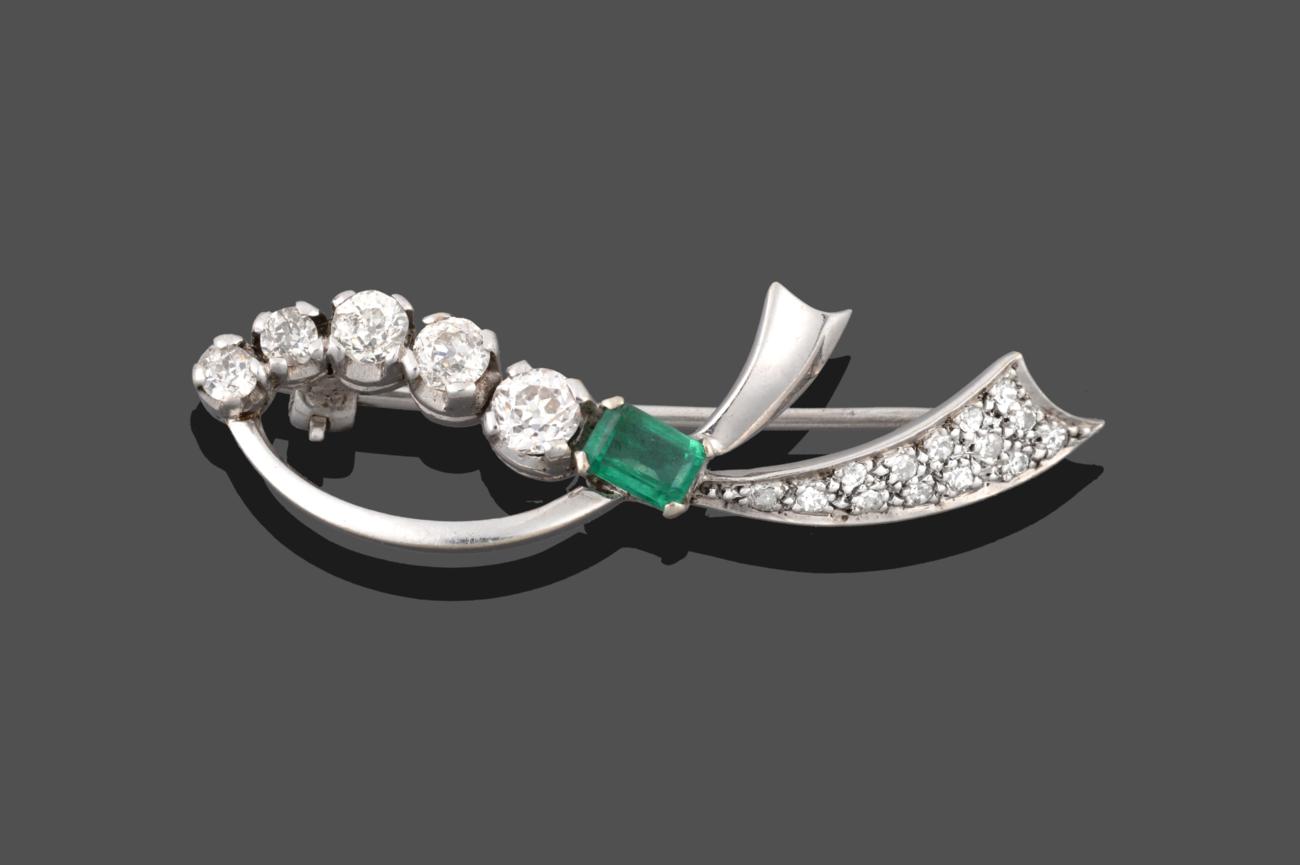 Lot 2035 - An Emerald and Diamond Brooch, realistically modelled as a white ribbon with an emerald-cut emerald