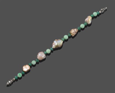 Lot 2038 - A Baroque Pearl, Emerald and Jade Bracelet, spherical emerald beads spaced alternately by spherical