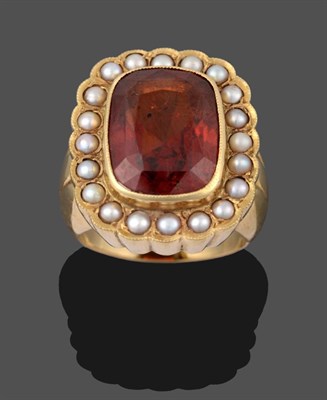Lot 2043 - An 18 Carat Gold Hessonite Garnet and Seed Pearl Cluster Ring, the cushion cut hessonite garnet...