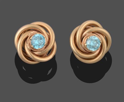 Lot 2048 - A Pair of Blue Zircon Knot Earrings, the round cut blue zircons in yellow claw settings to a...