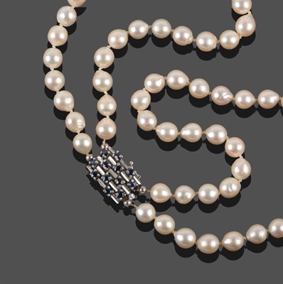 Lot 2058 - A Two Row Cultured Pearl Necklace, the 45:49 pearls knotted to an oblong clasp set with...