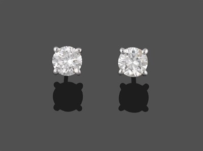 Lot 2060 - A Pair of Diamond Solitaire Earrings, round brilliant cut diamonds in claw settings, total...
