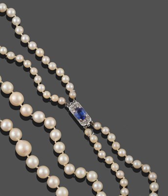 Lot 2063 - A Two Row Cultured Pearl Necklace, the graduated 65:72 pearls knotted to an oblong clasp comprising
