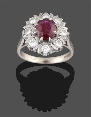 Lot 2065 - An 18 Carat White Gold Ruby and Diamond Cluster Ring, an oval cut ruby within a border of round...