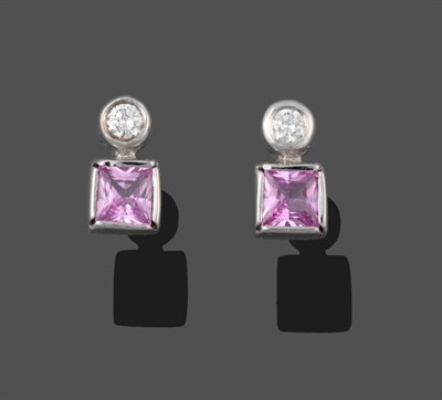 Lot 2067 - A Pair of 18 Carat White Gold Pink Sapphire and Diamond Earrings, a round brilliant cut diamond...