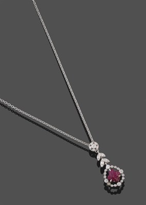 Lot 2072 - A Ruby and Diamond Pendant on Chain, the ruby carved in the form of a leaf, within a diamond frame