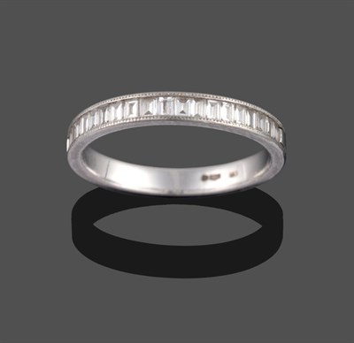 Lot 2076 - A Platinum Diamond Half Hoop Ring, the baguette cut diamonds channel set, on a plain polished shank