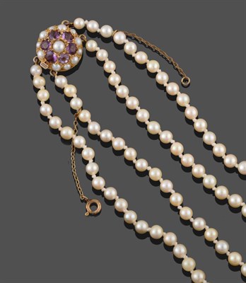 Lot 2081 - A Two Row Cultured Pearl Necklace, the 107:115 pearls knotted to an amethyst and cultured pearl...