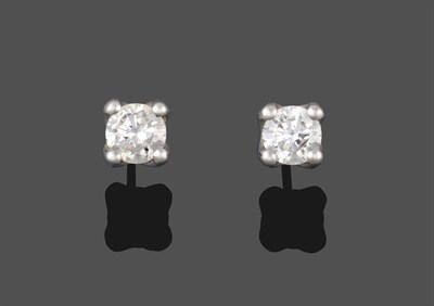 Lot 2082 - A Pair of Diamond Solitaire Earrings, the round brilliant cut diamonds in white claw settings,...
