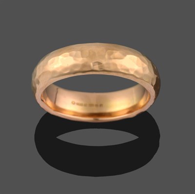 Lot 2097 - An 18 Carat Rose Gold Planished Band Ring, finger size S1/2 see illustration
