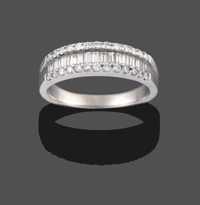 Lot 2114 - An 18 Carat White Gold Diamond Half Hoop Ring, a row of graduated baguette cut diamonds within...