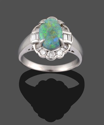 Lot 2117 - An Opal and Diamond Cluster Ring, the oval opal in a white claw setting, within a surround of round