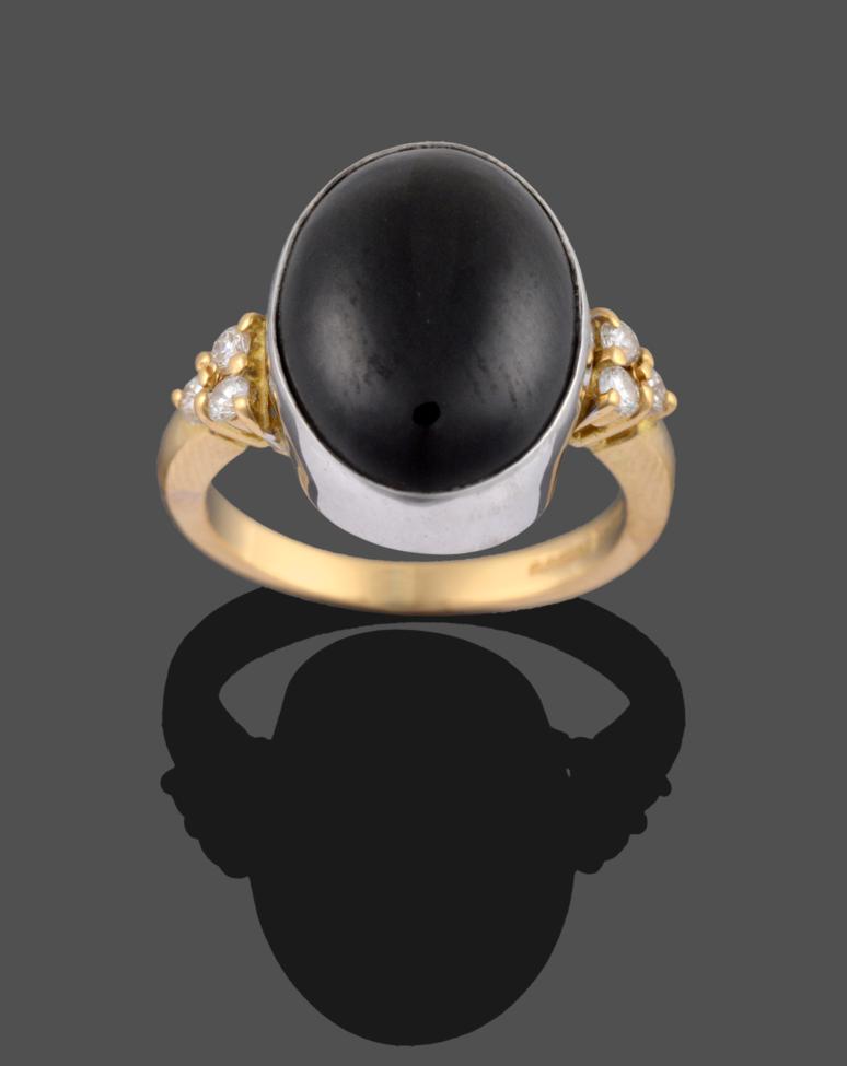 Lot 2128 - An 18 Carat Gold Onyx and Diamond Ring, the oval cabochon onyx in a white collet setting...