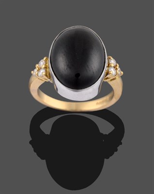 Lot 2128 - An 18 Carat Gold Onyx and Diamond Ring, the oval cabochon onyx in a white collet setting...