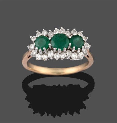 Lot 2135 - A 9 Carat Gold Emerald and Diamond Triple Cluster Ring, three round cut emeralds within a border of