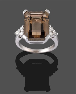 Lot 2142 - An 18 Carat White Gold Smokey Quartz and Diamond Ring, the emerald-cut smokey quartz in a white...