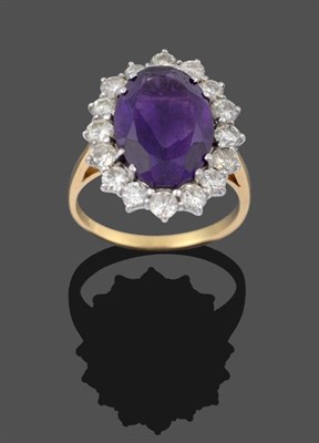 Lot 2153 - An 18 Carat Gold Amethyst and Diamond Cluster Ring, the oval cut amethyst in a white double...