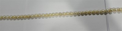 Lot 2155 - A Cultured Pearl Necklace, eighty-eight off-round cultured pearls knotted to a circular clasp...