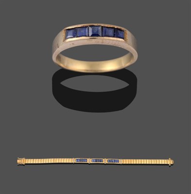 Lot 2157 - A Sapphire and Diamond Bracelet, three sections of six step cut sapphires spaced by pairs of...