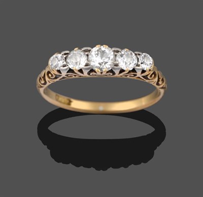 Lot 2163 - A Diamond Five Stone Ring, the graduated old cut diamonds in a scroll setting on a plain...