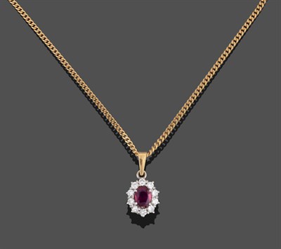 Lot 2178 - An 18 Carat Gold Ruby and Diamond Cluster Pendant on Chain, the oval mixed cut ruby within a border