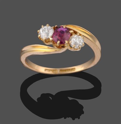 Lot 2183 - A Victorian 18 Carat Gold Ruby and Diamond Three Stone Ring, the cushion cut ruby between two...