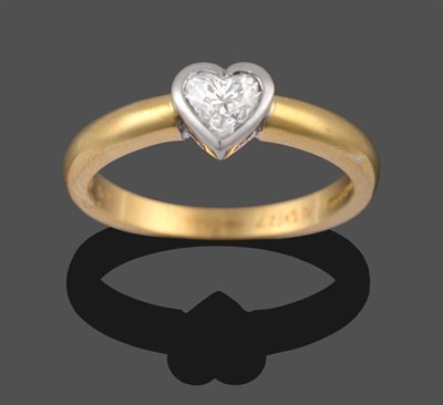 Lot 2187 - An 18 Carat Gold Heart Shaped Diamond Solitaire Ring, the diamond in a white rubbed over setting on