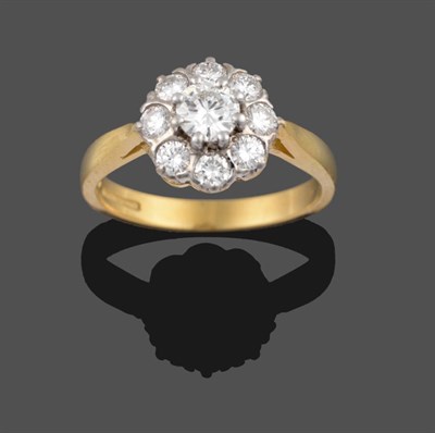 Lot 2188 - An 18 Carat Gold Diamond Cluster Ring, the central round brilliant cut diamond sits above a row...