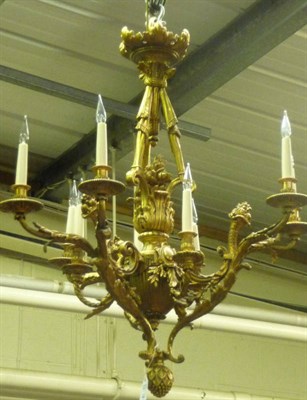 Lot 993 - A Gilt Metal Nine-Light Chandelier, in Louis XIV style with floriform boss and three linen sheathed