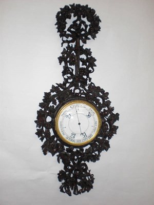 Lot 1076 - A Black Forrest Aneroid Barometer, circa 1880, case elaborately carved throughout depicting floral