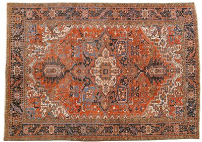 Lot 1084 - Heriz Carpet Persian Azerbaijan The terracotta field of angular vines and stylised flowers around a