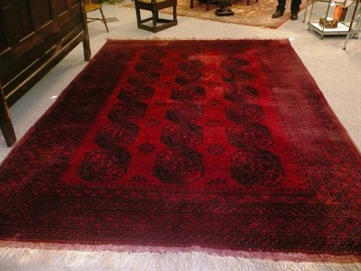 Lot 1085 - Afghan Carpet Afghan Turkestan The blood red field with three rows of quartered elephant foot...