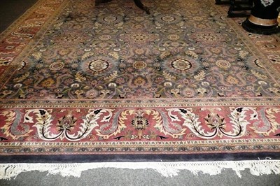 Lot 1087 - Large Indian Carpet The dove grey field with an allover design of palmettes and leafy vines...