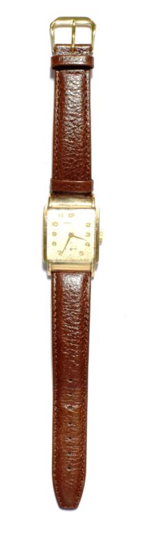Lot 19 - A 9 carat gold Garrard wristwatch with unusual hooded lugs