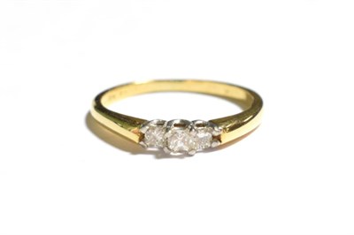 Lot 26 - A diamond three stone ring, the graduated princess cut diamonds in white claw settings, to a yellow